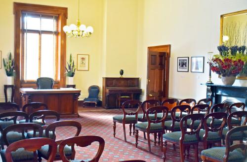 Rows of seating either side of a central aisle, in a traditional-style room